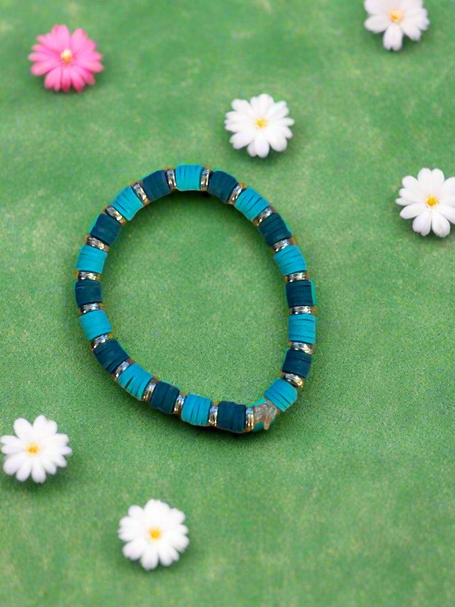 green bracelet with gold accent
